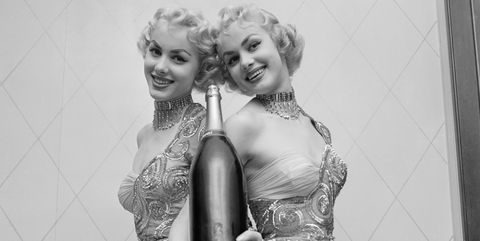 Ellen and Alice Kessler Holding a Bottle of Champagne