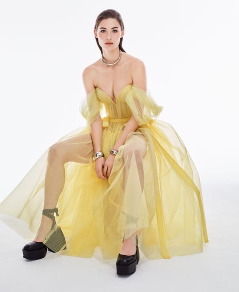 grace elizabeth sits in a yellow tulle dress wearing patent leather platform heels