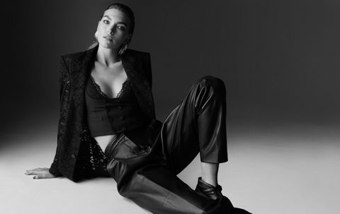 arizona muse poses in black trousers, camisole and jacket