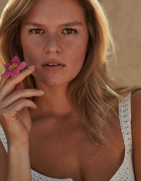 portrait of anna ewers holding a flower