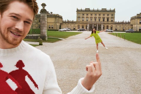 joe alwyn pretends to balance alison oliver on his finger