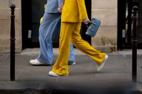 street style attendees wearing blue and yellow suit pants