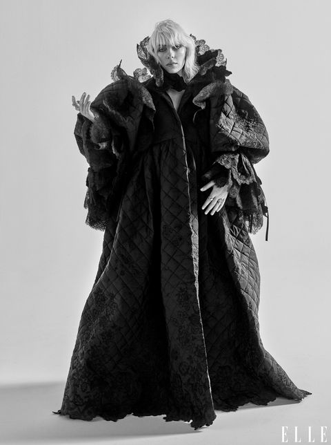 billie eilish poses in an elaborate coat