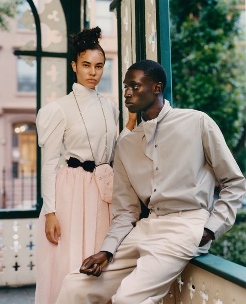 male and female model pose on porch in pastel and white clothes