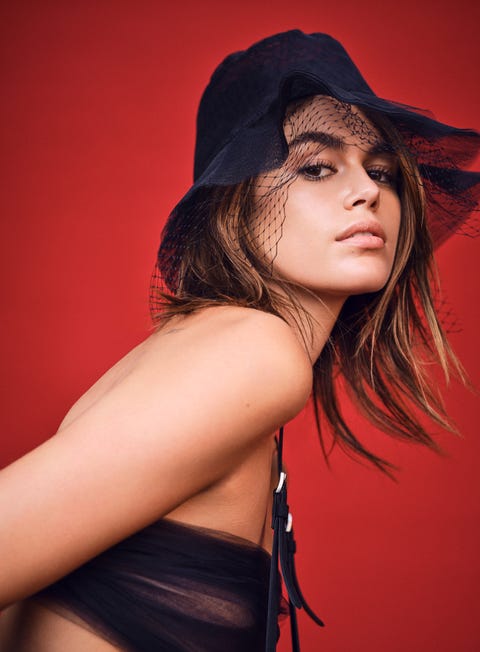 kaia gerber wears black bucket hat