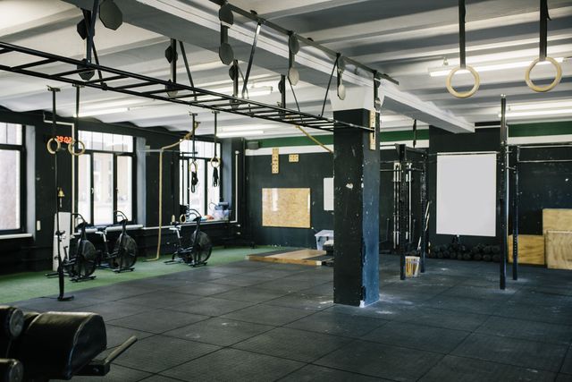 an empty gym scene with various types of equipment ready for use
