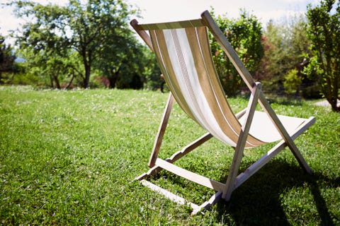 Empty deckchair in sunlit garden