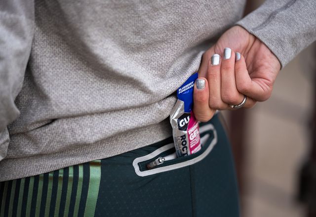 runners pulling energy gel form pocket