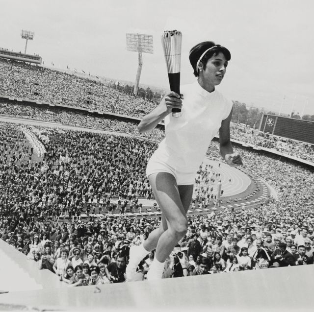 original caption a feminine first mexico city mexico's norma enriqueta basilio, the first woman in the history of the modern olympic games to light the olympic fire, runs up the ninety steps with the olympic torch during the opening ceremonies here october 12, 1968