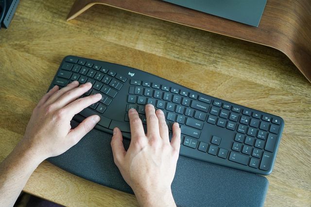 a man typing on a keyboard
