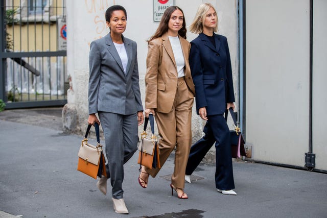 three women wear matching suits sets while attending milan fashion week in 2020