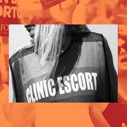 woman wearing a vest that says "clinic escort"