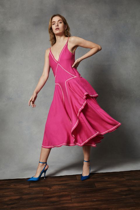 a model wears a pink linen blend dress with a stitch detail