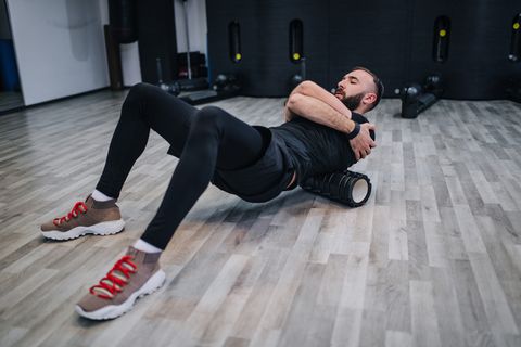 Exercising with foam roller in the gym