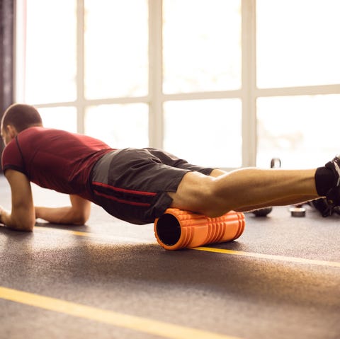 Exercising with foam roller in the gym