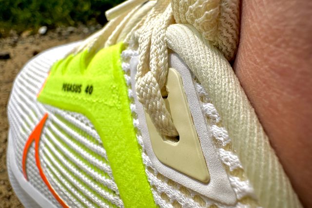 close up of someone wearing running shoes with an extra eyelet