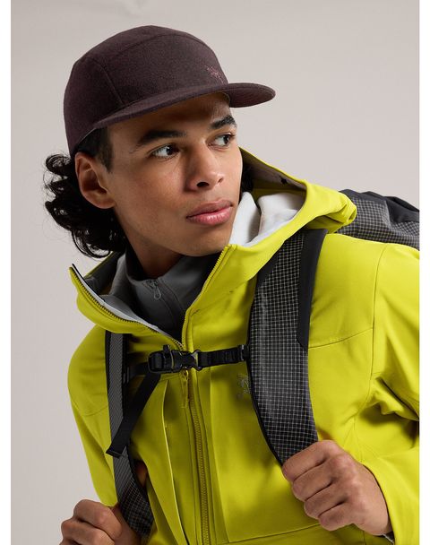 a man wearing a hat and a yellow jacket