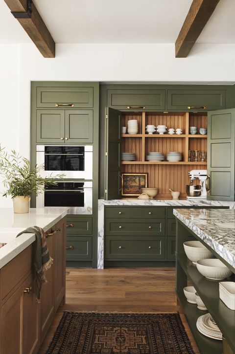 hollywood stunt man, tammy randall wood's spanish colonial home in the santa monica mountains designed by interior archaeology kitchen paint winter white, benjamin moore walls and ceiling and custom, interior archaeology cabinetry ovens wolf counters terrazzo left and marble right, walker zanger