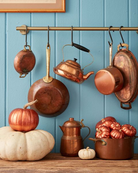 pumpkins painted cooper in a kitchen scene with copper pots