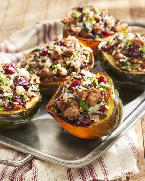 sausage and wild rice stuffed acorn squash on a metal serving tray