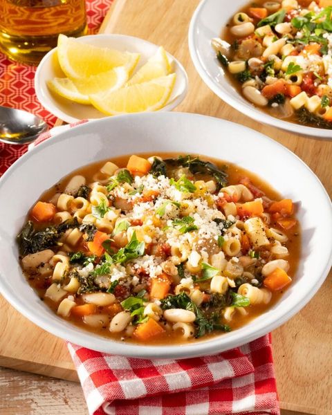 pasta fagioli with lemon wedges and red checkered napkin