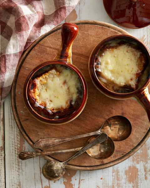classic french onion soup in two brown soup crocks