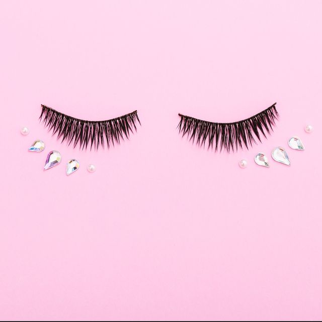 false eyelashes and decoration for make up on pink background