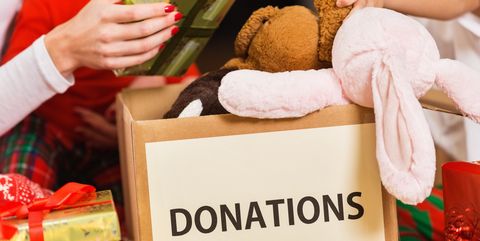 Family donating gifts and toys to charity for Christmas holiday