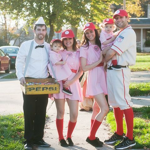 a family halloween costume inspired by a league of their own, with two adult rockford peaches, two baby peaches, one peach coach and a candy seller