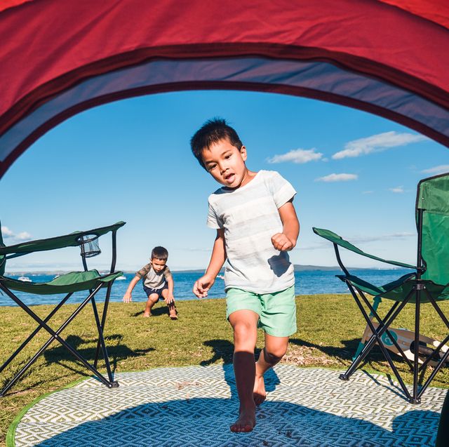 boy running into camping tent