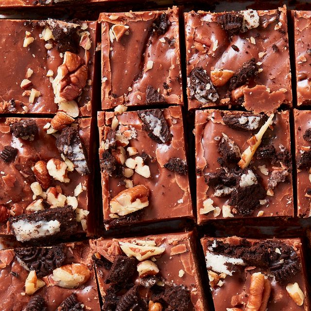closeup of pieces of fantasy fudge topped with pecans and crushed oreos