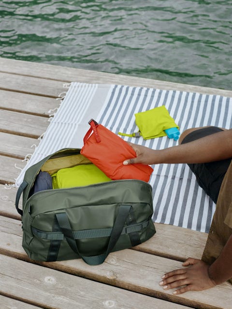 an away duffle bag filled with packing cubes in a roundup of away luggage outdoor launch 2022
