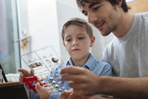 Father and son building model car