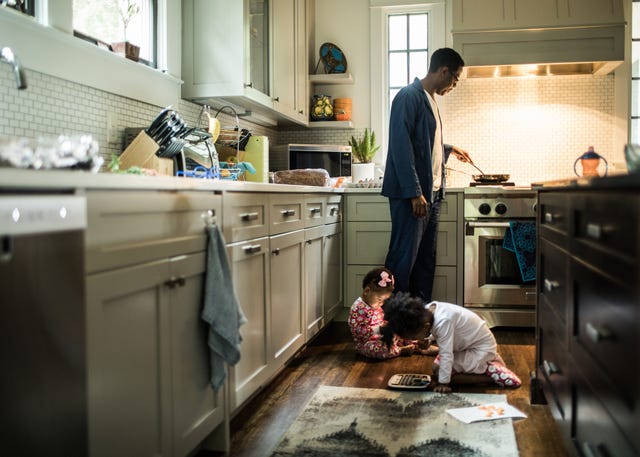 Father cooking breakfast for daughters in kitchen father cooking breakfast for daughters in kitchen