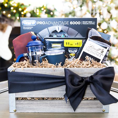 fathers day grooming themed gift basket with electric toothbrush, razor, socks, small toiletries bag, chocolate bar, french coffee press, and coffee mug presented in whitewashed wood crate