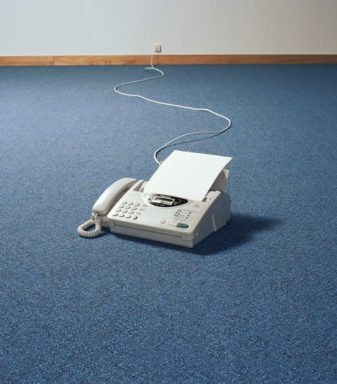 Fax machine on floor of empty room