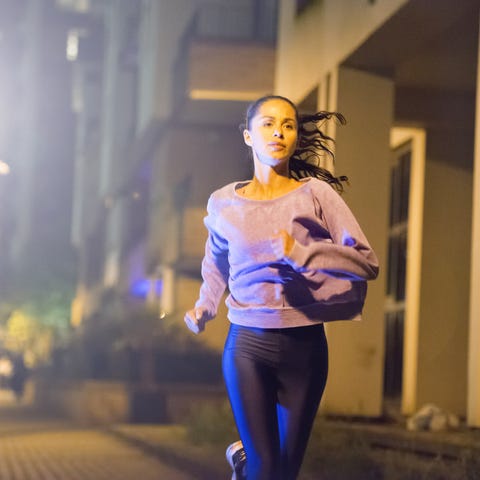 female athlete, urban setting at night