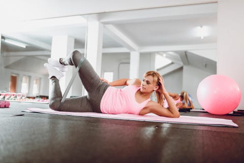 Female Athlete Working Out With Rubber Band In Gym Female Athlete Working Out With Rubber Band In Gym