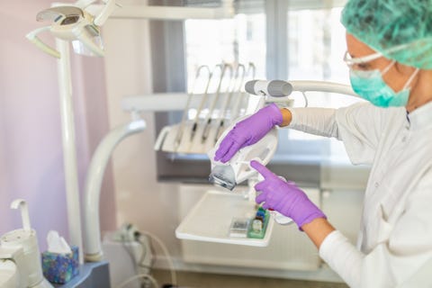 female doctor cleaning dental office