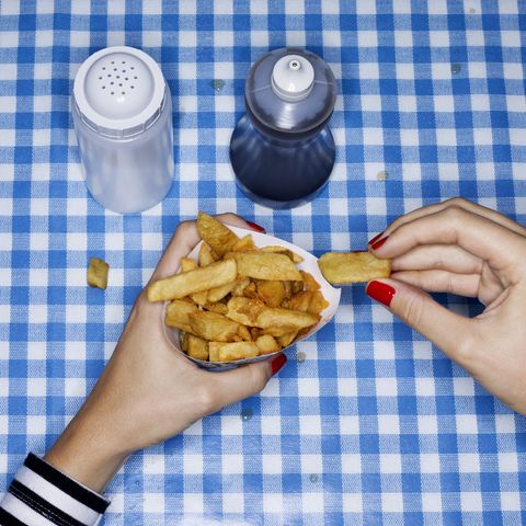 Female eating chips with salt and vinegar