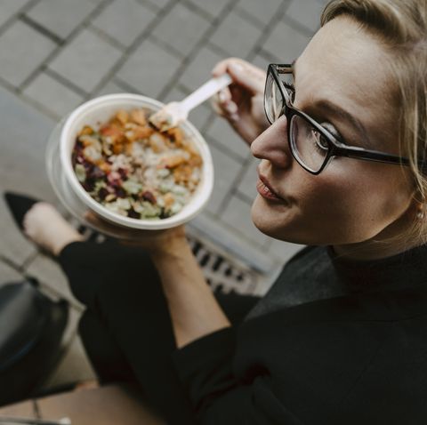 female entrepreneur with salad bowl looking away