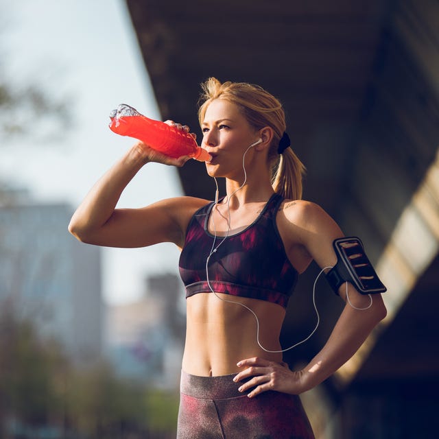 Female runner having break and drinking refreshment drink female runner having break and drinking refreshment drink