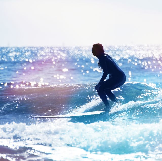 female surfer riding the wave