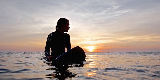 female surfer waiting for wave, praia, santiago island, cape verde