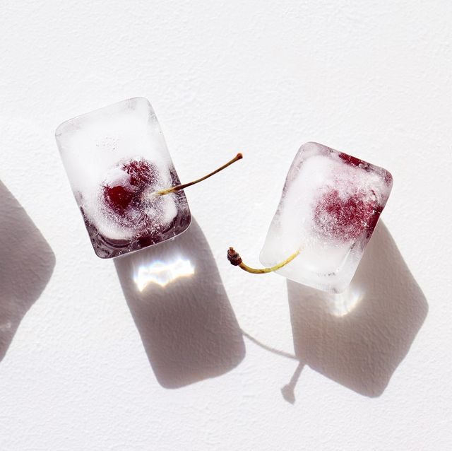 frozen cherries in ice cubes on white textured background hard sunlight, dark shadow, flat lay preservation of summer vitamins for winter concept of shock freezing food horizontal poster