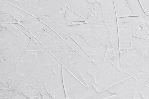 white abstract background of paste filler and bonding plaster with irregular dashes and strokes