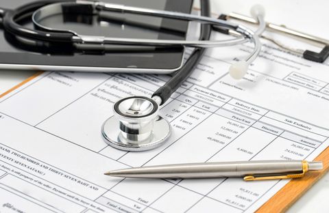 filling medical form, document, stethoscope