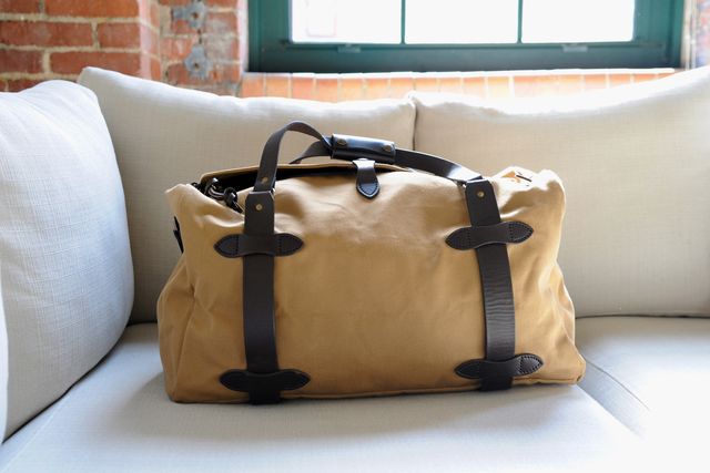 filson duffel bag on a couch
