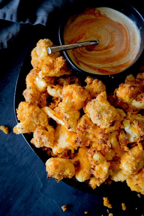 air fried buffalo cauliflower bites with dip in black bowl