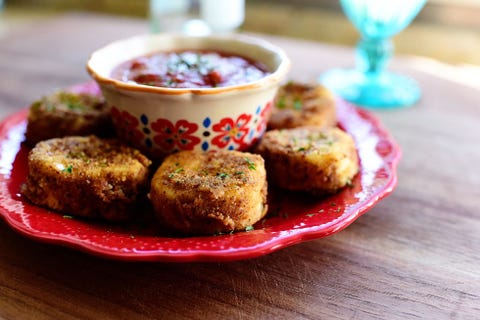 fried goat cheese on red plate with sauce